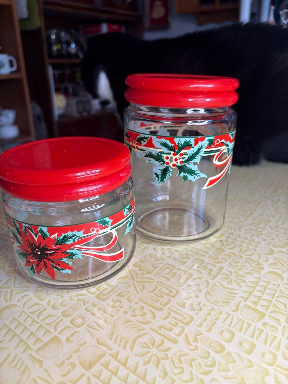 Vintage Holiday Glass Storage Jars with Red Lids and Festive Poinsettia Design